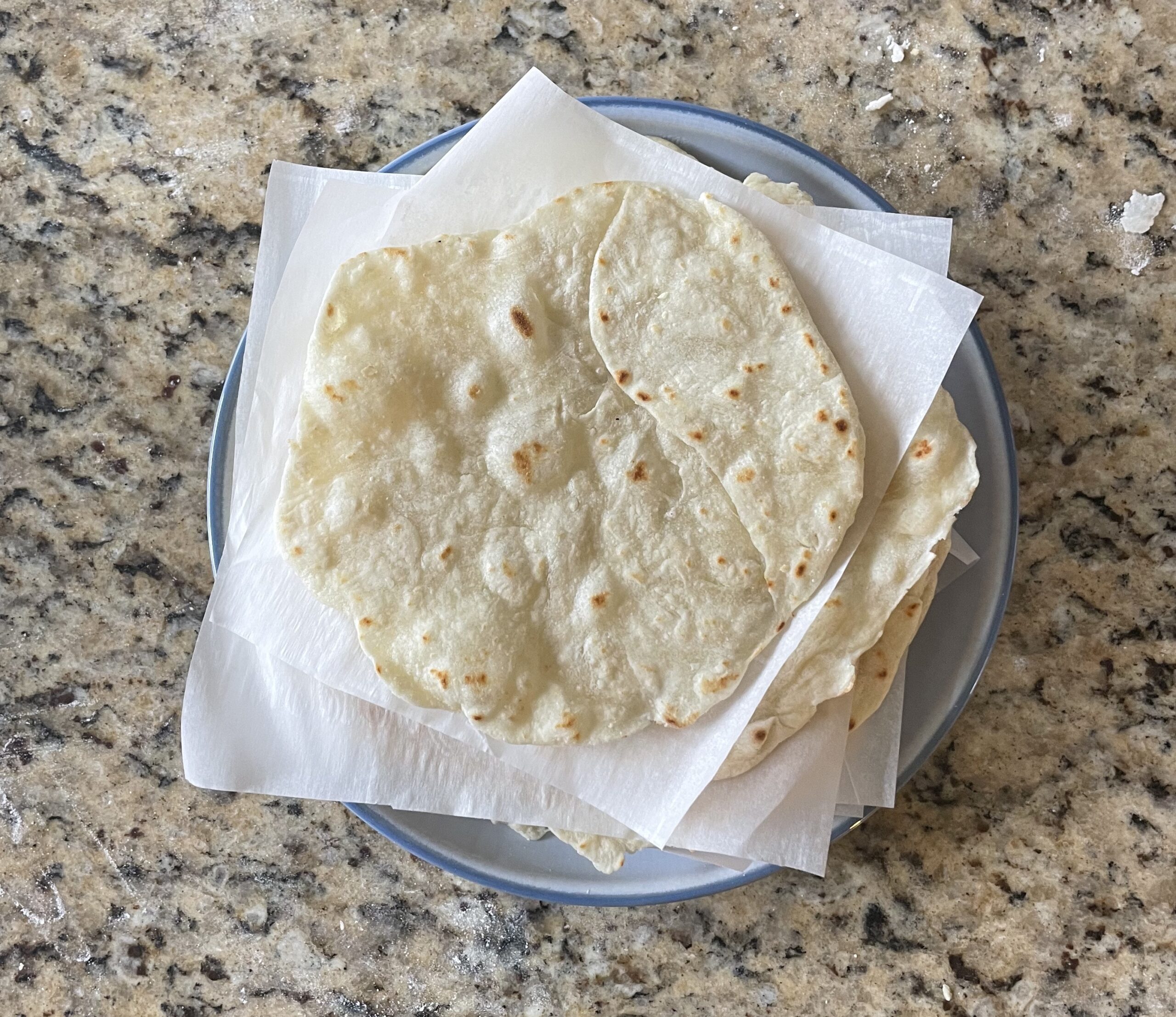 This photo shows all of the cooked tortillas stacked on eachother