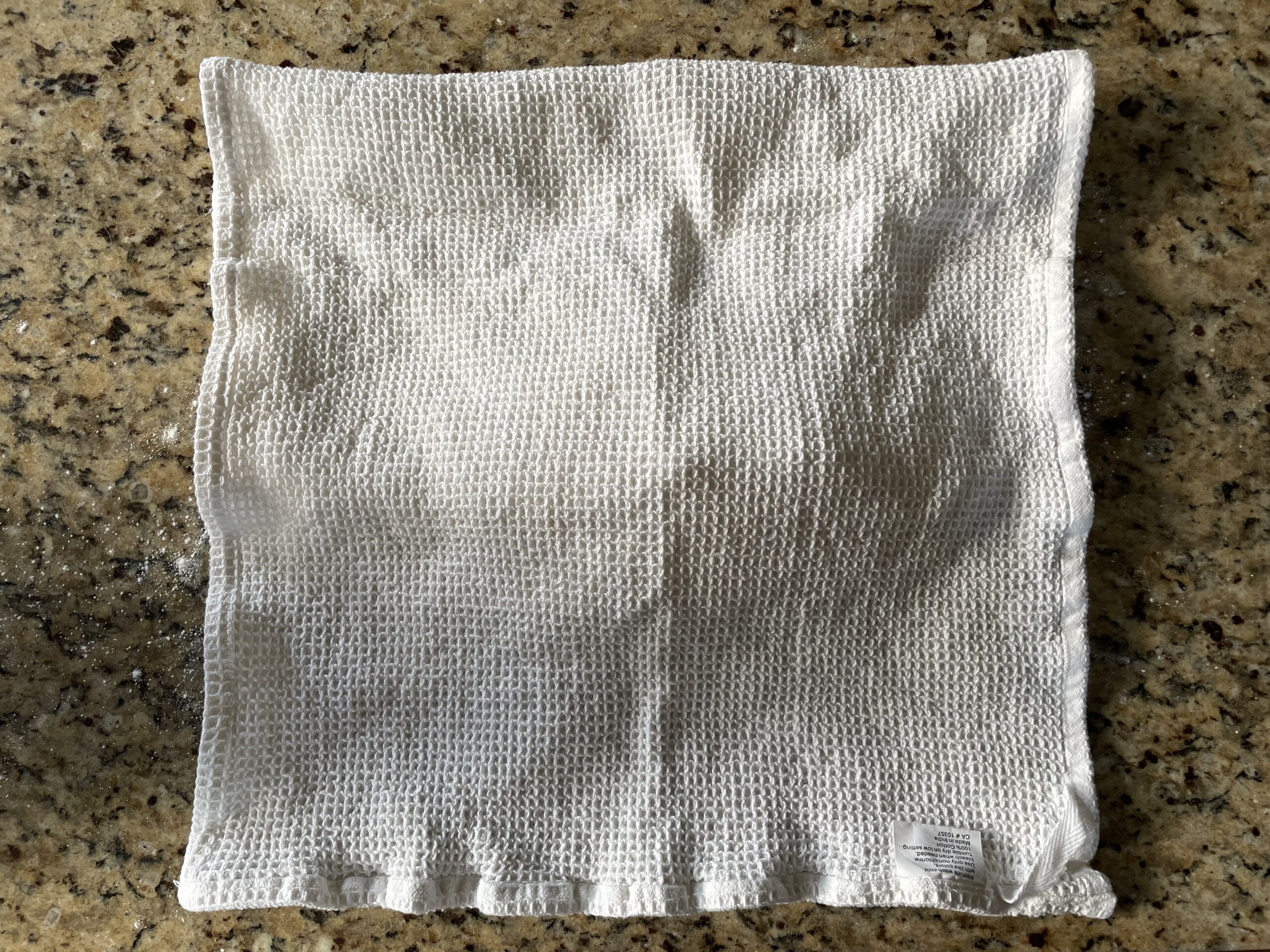 This photo shows the covered pan of cut up english muffins