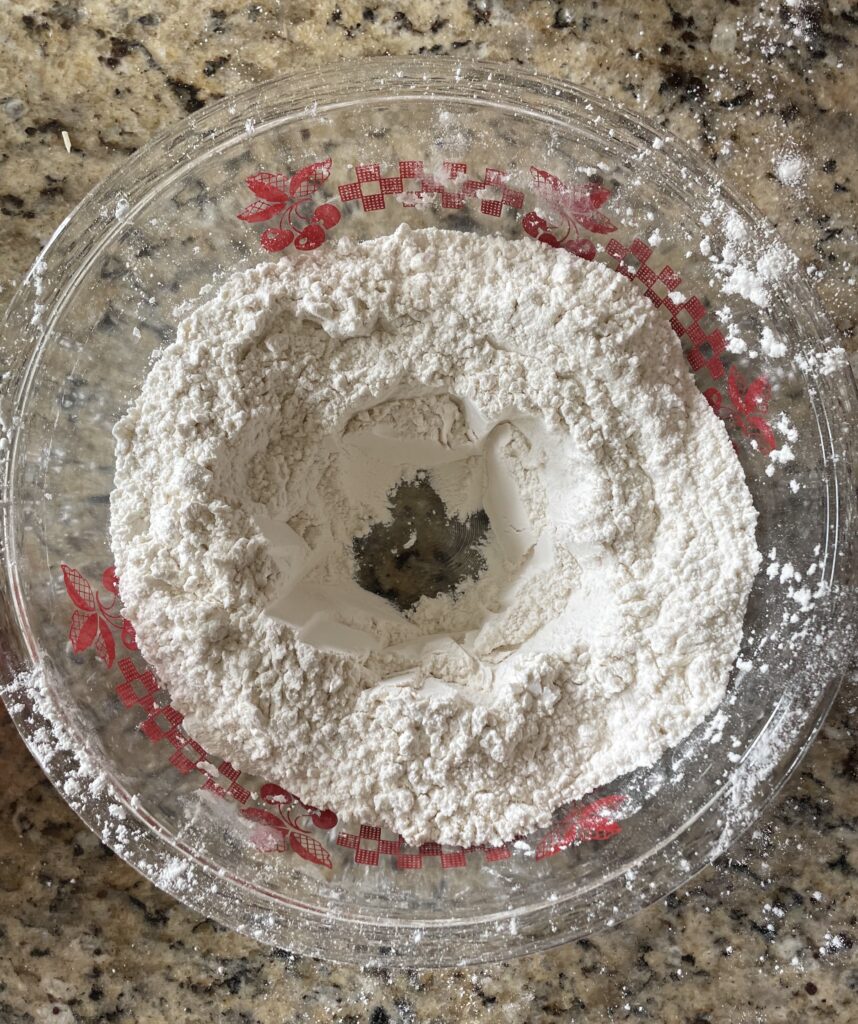 this image shows the hole that needs to be made in the dry ingredients for the wet ingredients
