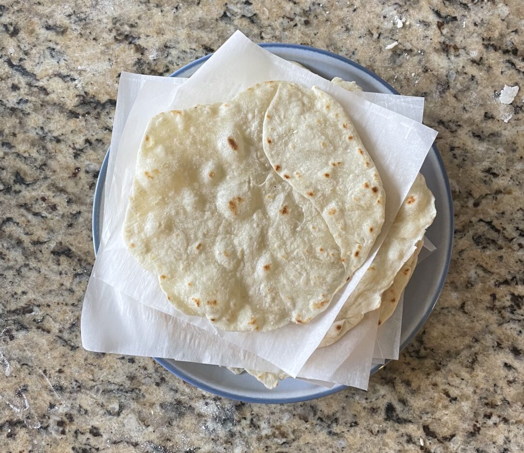 This photo shows all of the cooked tortillas stacked on eachother