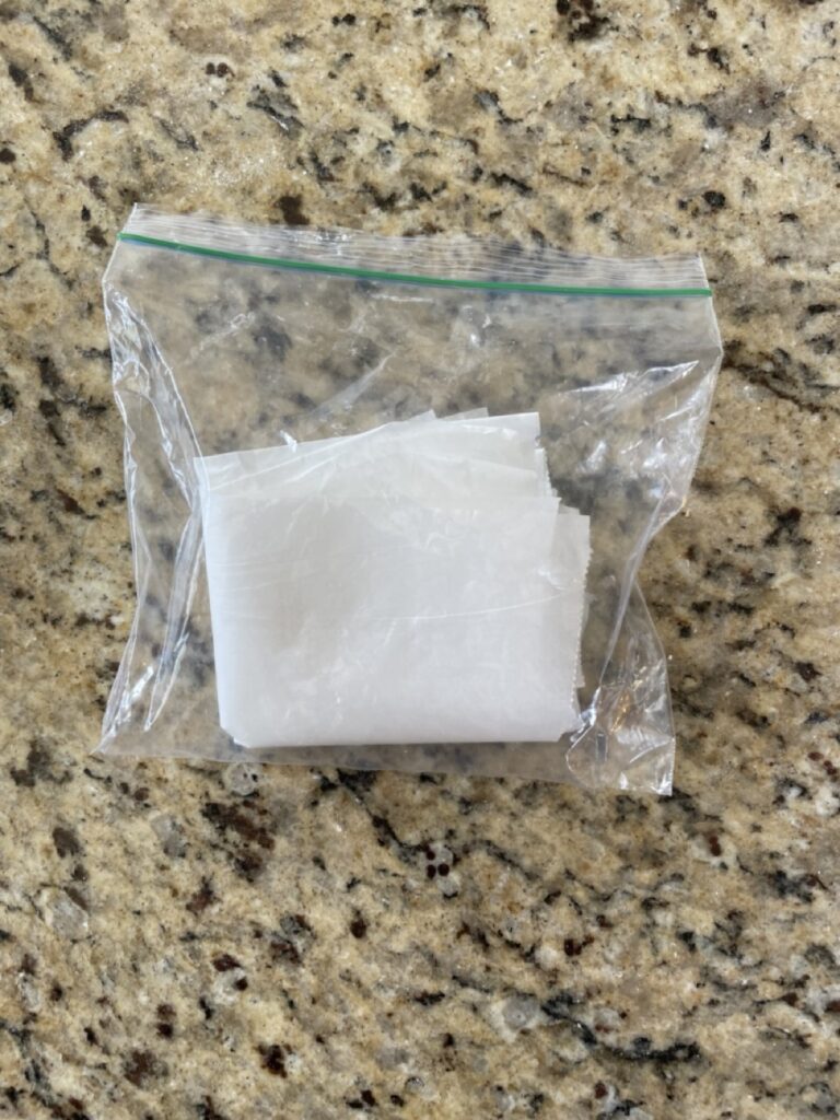 shows a plastic bag with folded up parchment paper in it